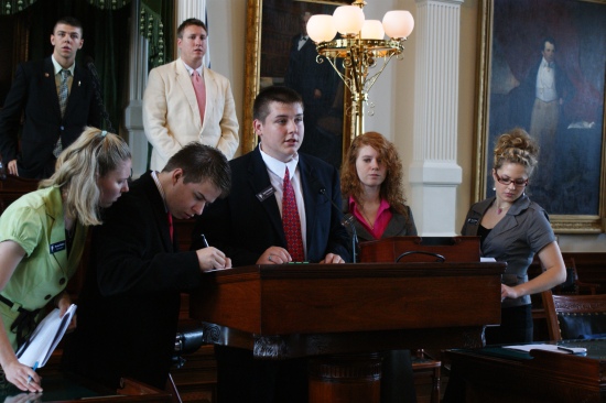 SONY DSC Kyle Griesinger presenting a bill